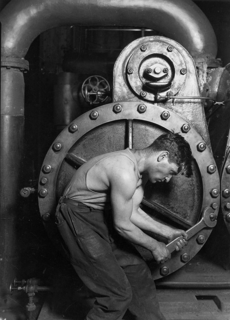 Lewis_Hine_Power_house_mechanic_working_on_steam_pump